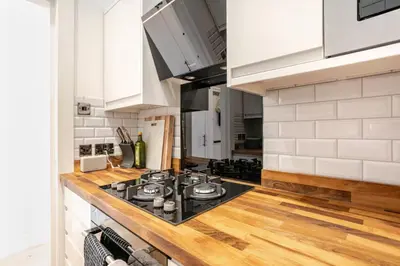 a kitchen with a black stove top oven at Warm upgraded top-floor flat in Finnieston in Glasgow