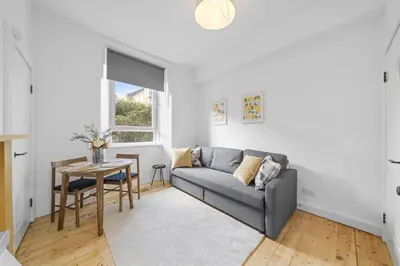 a living room with a couch and a table at City-Close 1-Bedroom Apartment - Edinburgh in Edinburgh