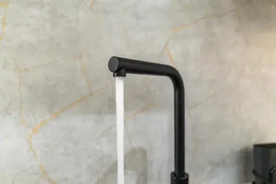 a black and white luggage handle in front of a wall at City-Close 1-Bedroom Apartment - Edinburgh in Edinburgh