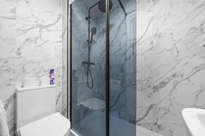 a bathroom with a shower with a toilet and a sink at City-Close 1-Bedroom Apartment - Edinburgh in Edinburgh