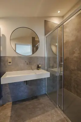 a bathroom with a sink and a mirror at Old Church Apartment 4 in Oban