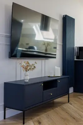 a blue dresser in a room with a mirror at Old Church Apartment 4 in Oban