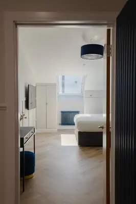 a bedroom with a bed and a desk in it at Old Church Apartment 5 in Oban