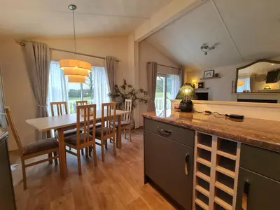 a kitchen and dining room with a table and chairs at 10 lochview in Moffat