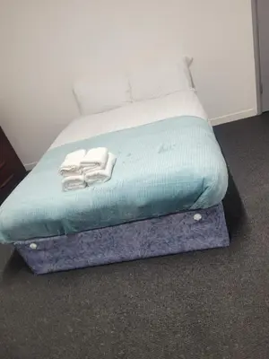 a bed with towels sitting on top of it at Akwaaba services in Moffat