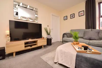 a living room with a large flat screen tv at Peaceful Village Flat 2 Bedrooms in Douglas