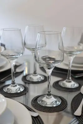 a group of wine glasses sitting on a table at Stylish 4Bed Home Free Parking 20 Min to Edinburgh in Livingston