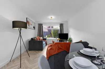 a living room with a table and a couch at Stylish 4Bed Home Free Parking 20 Min to Edinburgh in Livingston