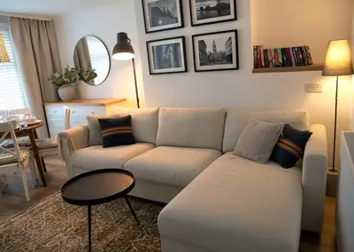 a living room with a couch and a table at Justina's House in East Kilbride