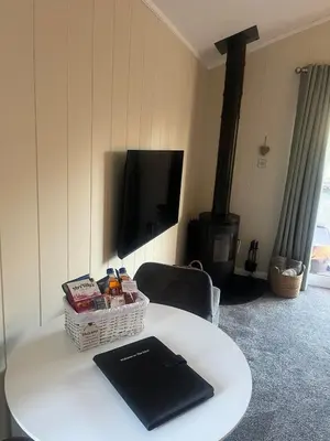 a white table with a book on top of it at The Eden, Cosy 1 bed lodge with riverside views in Crieff