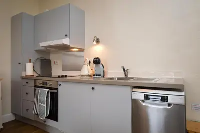 a kitchen with a sink and a dishwasher at Seascape in Kames