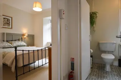 a bedroom with a bed and a toilet at Seascape in Kames