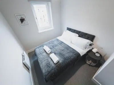 a bedroom with a bed and a window at Finnieston Apartment in Glasgow