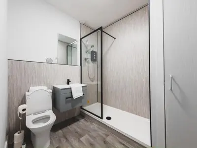 a bathroom with a toilet and a shower at Finnieston Apartment in Glasgow