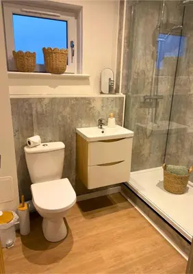 a bathroom with a toilet and a shower and a sink at 7 min from Edinburgh Airport 2 Bedroom Apartment in Edinburgh