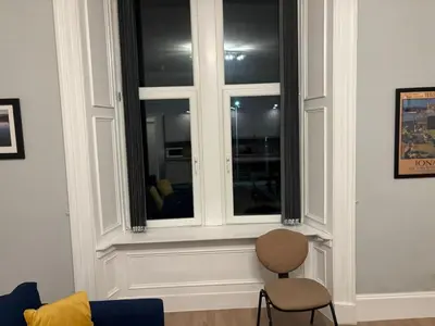 a room with a window with a chair in it at No 1 Westbay Apartment in Dunollie