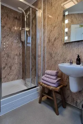 a bathroom with a sink and a shower at Craigbuie Guesthouse in Killin