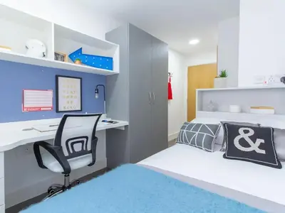 a bedroom with a bed and a desk and a chair at Collegelands in Glasgow in Glasgow