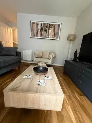 a living room with a coffee table and a couch at Pearl House in Moffat