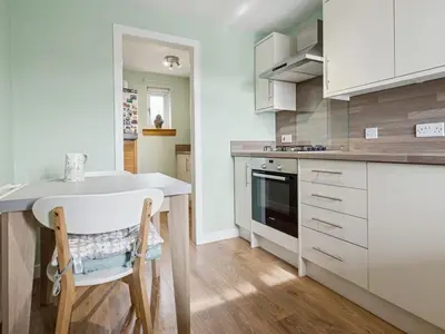 a kitchen with white cabinets and a white counter top at Spacious 2 Bed in Falkirk in Falkirk