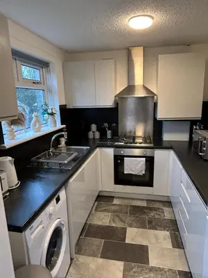 a kitchen with a stove and a dishwasher in it at 3BR Home Sleeps 10 with Private Drive Near Park in Newton Mearns
