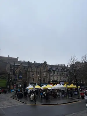 a group of tables and umbrellas in front of a building at Castle flat in Edinburgh in Edinburgh