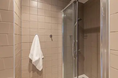 a bathroom with a shower with a glass door at For Students Only Stylish Studios in Glasgow in Glasgow