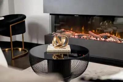 a table with two gold rings on it in front of a fireplace at Near Transport - Hot tub - Fireplace - Sleeps 2 in Edinburgh