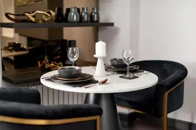 a table with two chairs and a table with wine glasses at Near Transport - Hot tub - Fireplace - Sleeps 2 in Edinburgh