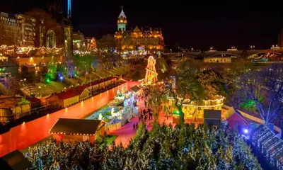a city lit up at night with christmas lights at Heart Of Edinburgh City Flat in Edinburgh