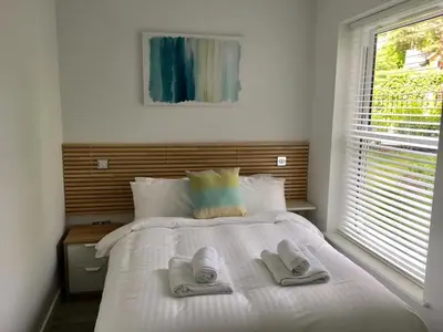 a bedroom with a bed with two slippers on it at The Palms in Moffat