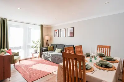 a living room with a table and a couch at Henderson House - West End 3 Bedroom Family Home in Glasgow