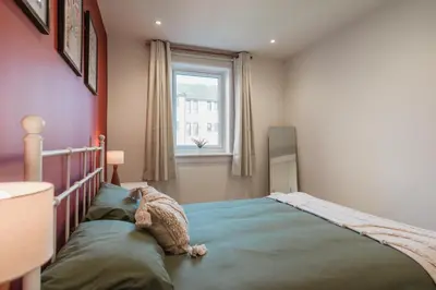 a bedroom with a large bed in a room at Henderson House - West End 3 Bedroom Family Home in Glasgow