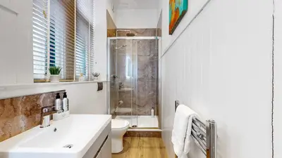a bathroom with a shower and a sink and a toilet at The Steamie on Bath St in Glasgow
