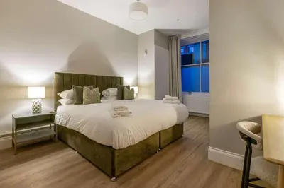 a bedroom with a large bed and a window at The Steamie on Bath St in Glasgow