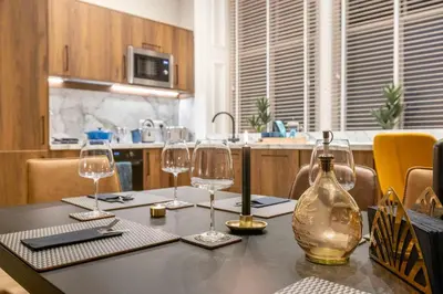 a table with wine glasses and a bottle on it at The Steamie on Bath St in Glasgow