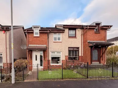 a brick house with a fence in front of it at Angel House - 3 bedrooms close to Airdrie Centre in Airdrie