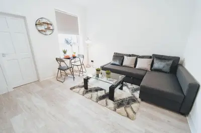 a living room with a couch and a table at Top Floor 1BR Wishaw Flat with Parking in Wishaw
