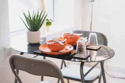 a table with plates of food on top of it at Top Floor 1BR Wishaw Flat with Parking in Wishaw