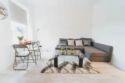 a living room with a couch and a table at Top Floor 1BR Wishaw Flat with Parking in Wishaw