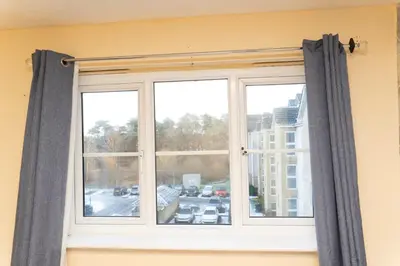 a window with gray curtains in a room at 2 bed flat near Livingston North Station in Livingston