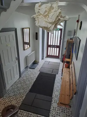 a room with a hallway with a door and a ceiling at Brewery house in Newton Stewart