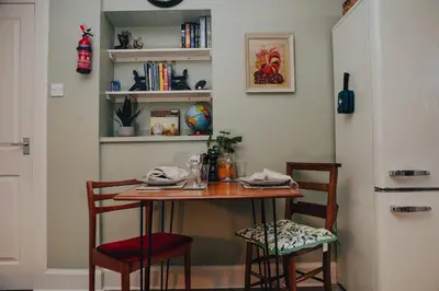a table and two chairs in a room with a table at Snug 1 Bed Apartment in Edinburgh's Juniper Green in Edinburgh