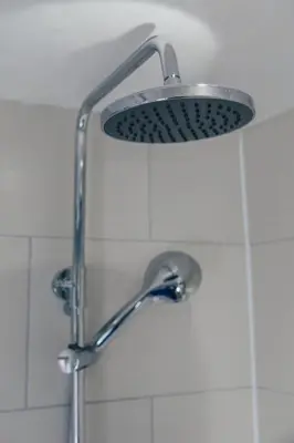 a shower with a shower head in a bathroom at Snug 1 Bed Apartment in Edinburgh's Juniper Green in Edinburgh