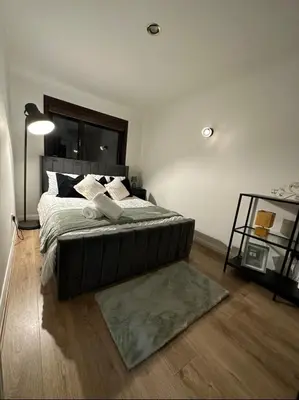 a bedroom with a large bed and a rug at Hydro Secc House Glasgow 10 minute walk in Glasgow