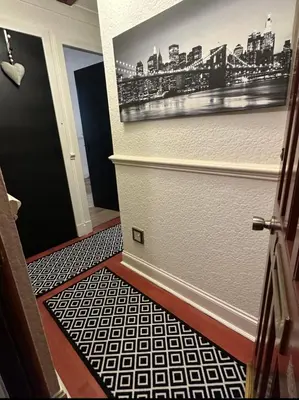 a hallway with a door with a picture of a city at Hydro Secc House Glasgow 10 minute walk in Glasgow