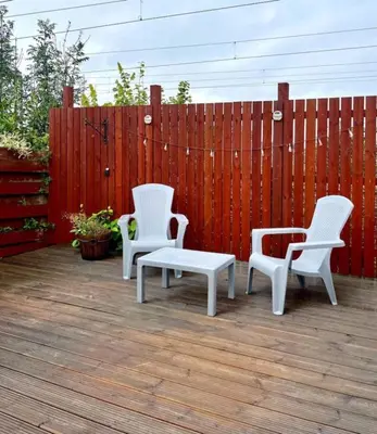 three white chairs and a bench on a patio at Clyde Fifty Two - Glasgow Apartment in Glasgow