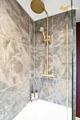 a shower in a bathroom with a marble wall at 3Bed House I Sleeps 6 I Dunfermline in Dunfermline