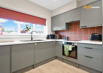 a kitchen with gray cabinets and a sink at 3Bed House I Sleeps 6 I Dunfermline in Dunfermline