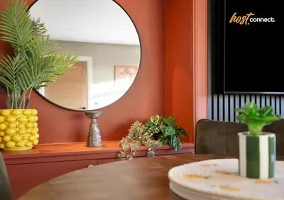 a dining room with a round mirror and a table at 3Bed House I Sleeps 6 I Dunfermline in Dunfermline